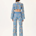 SS26-T-1002-38 raisa_vanessa denim-lace-crop-top-with-gold-metal-centered-flower-embroidery-sleeves